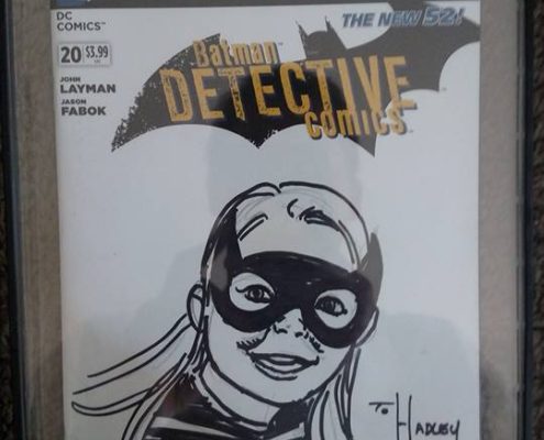A batman comic book with batgirl on it.