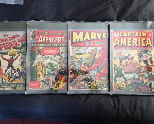 A set of five marvel comics are on display.