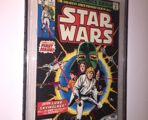 A framed star wars comic book cover hanging on the wall.